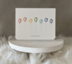 Birthday greeting card featuring a rainbow of watercolour balloons