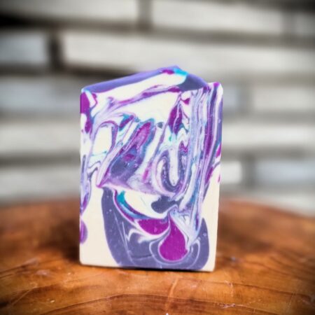 Handcrafted bar soap with dark and light purple, and white swirls; scented in lavender.
