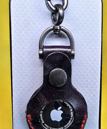 Black leather Apple AirTag cover with red stitching
