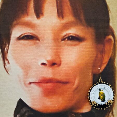 my daughter modeling the beaded owl medalian earrings