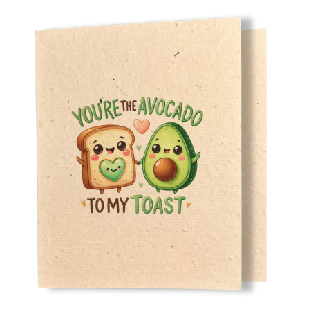 plantable greeting card, natural coloured paper, embedded with wildflower seeds, an image in kawaii style of a piece of toast and an avocado holding hands, sentiment reads you're the avocado to my toast