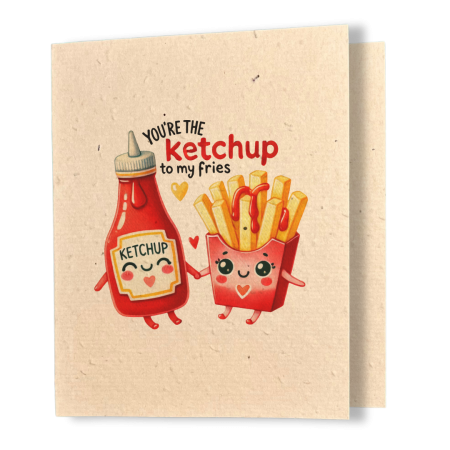 plantable greeting card, natural coloured paper, embedded with wildflower seeds, an image in kawaii style of a bottle of ketchup and some french fries holding hands, the sentiment reads you're the ketchup to my fries