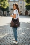 A Slouchy multi pockets eggplant color bag with iridescent hardware and decorative zipper tassels