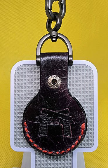 Black leather apple air tag with red stitching with a lobster clasp keychain