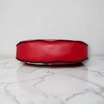 Red floral print slouch bag, matte black hardware.