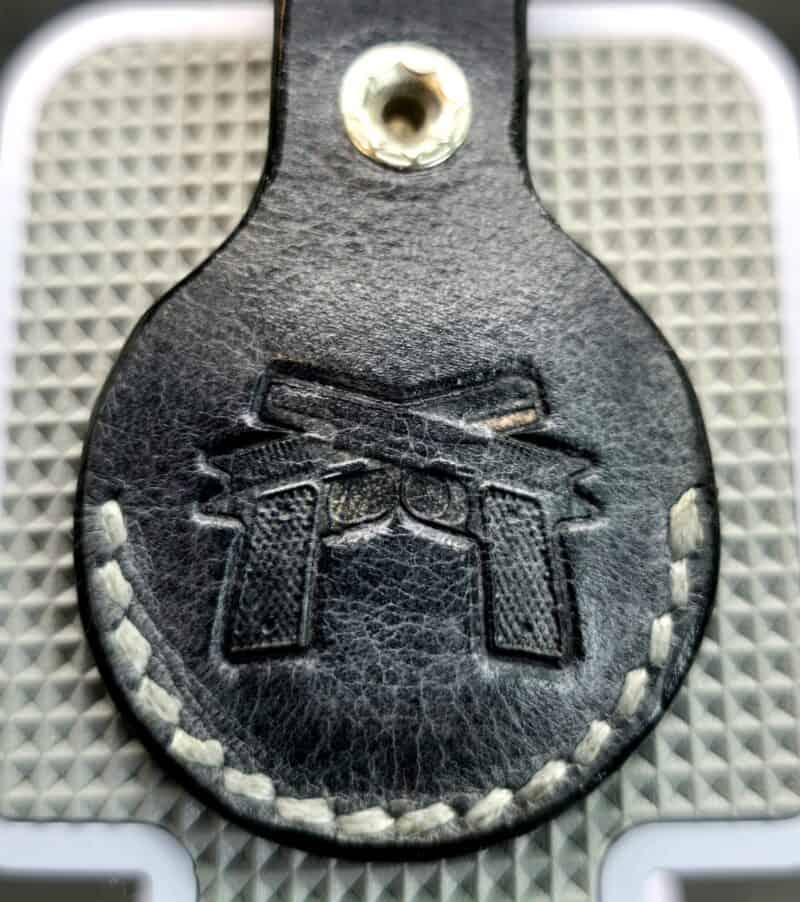 Charcoal-Gray-Leather-Apple-AirTag-Cover-with-guns-stamp-on-a-Keychain-AT17D-e1748022645776