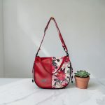 Red floral print slouch bag, matte black hardware.