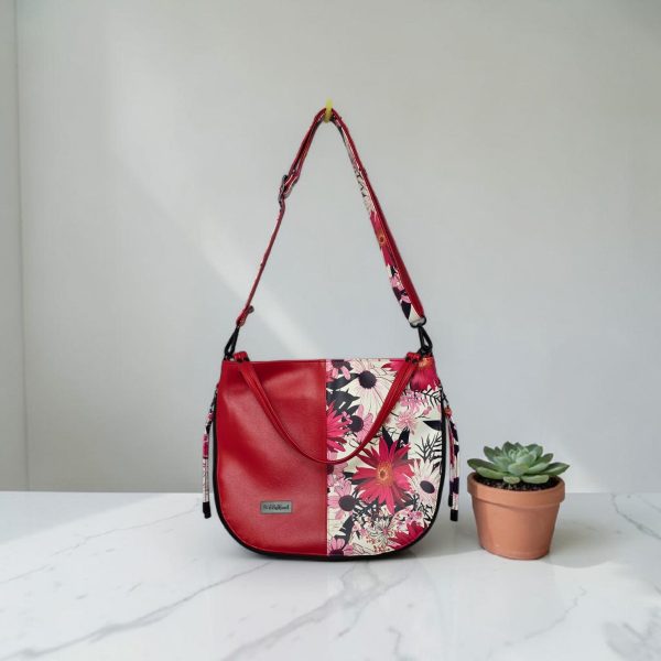 Red floral print slouch bag, matte black hardware.