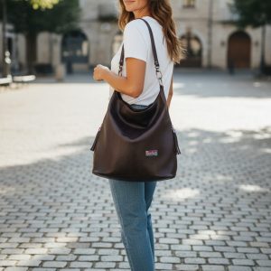 A Slouchy multi pockets eggplant color bag with iridescent hardware and decorative zipper tassels