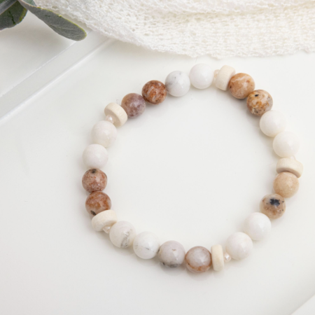 Stretch bracelet of iridescent Mexican morado opal beads, freshwater pearls, and warm wood rondelles on elastic cord.