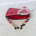 Red floral print slouch bag, matte black hardware.
