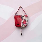 Red floral print slouch bag, matte black hardware.