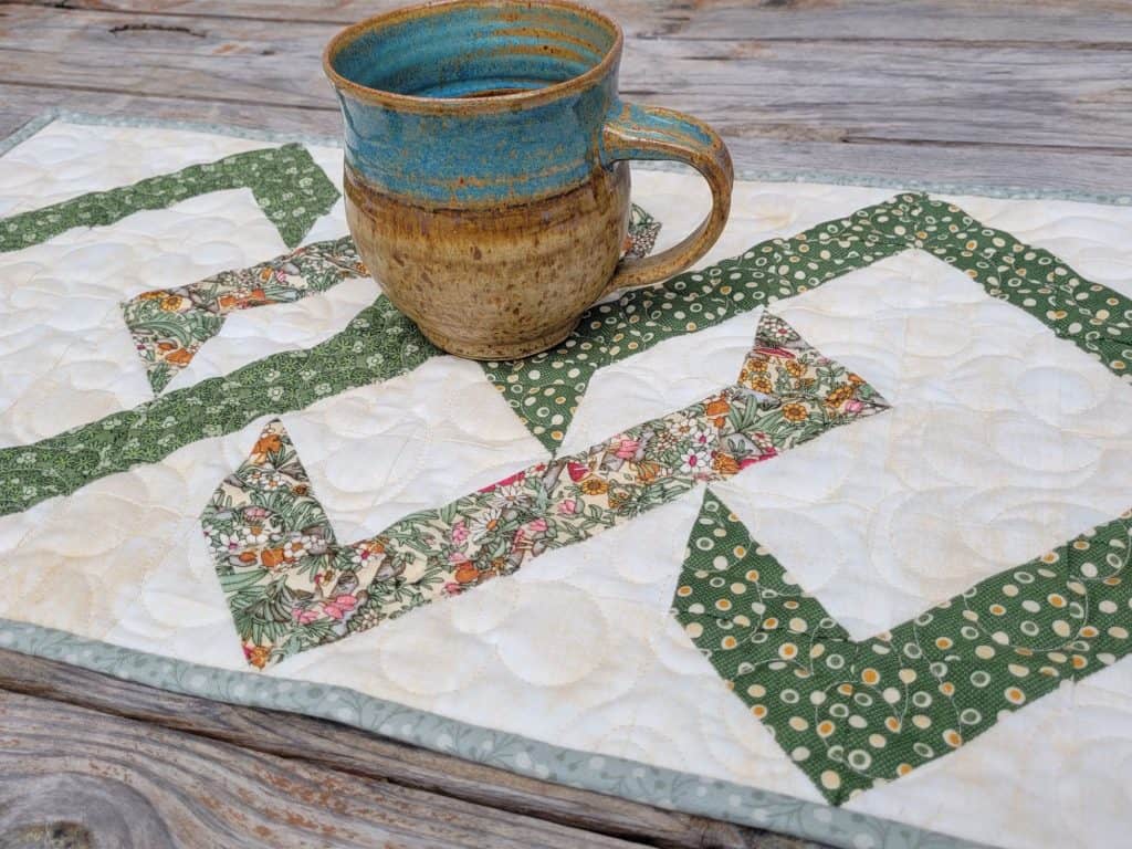 quilted table runner with a pottery mug