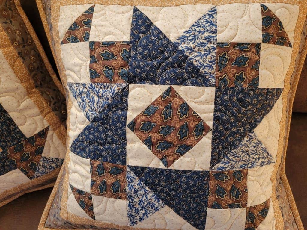 Quitled patchwork pillow in brown and blue