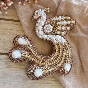 Golden peacock brooch